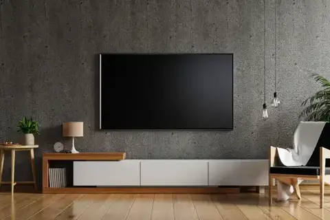 Flat-screen TV mounted on a living room wall above a media console